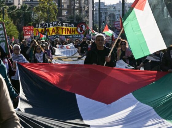 Protesters hold Palestinian flags as they march towards the Israeli embassy during a demonstration in solidarity with Palestinians, in Athens on November 29, 2025. (Photo by Aggelos NAKKAS / AFP)